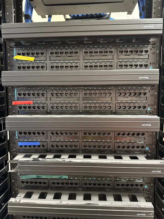 48-port Cat6 patch panels terminated and labeled in an IDF
