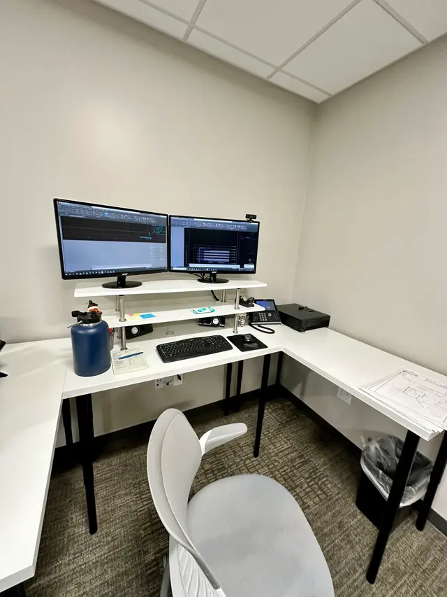 Corner desk dual monitor workstation set up with clean cable management