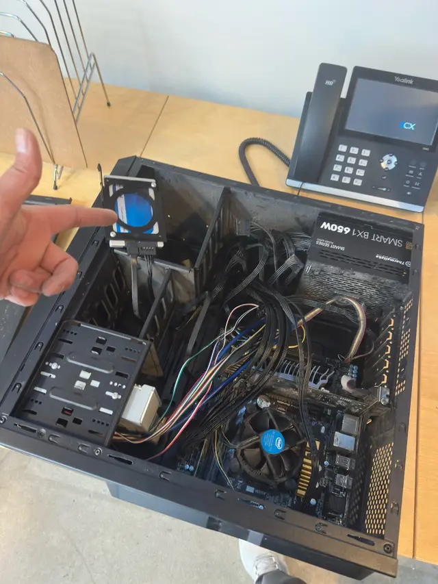 Technician replacing components inside a desktop PC