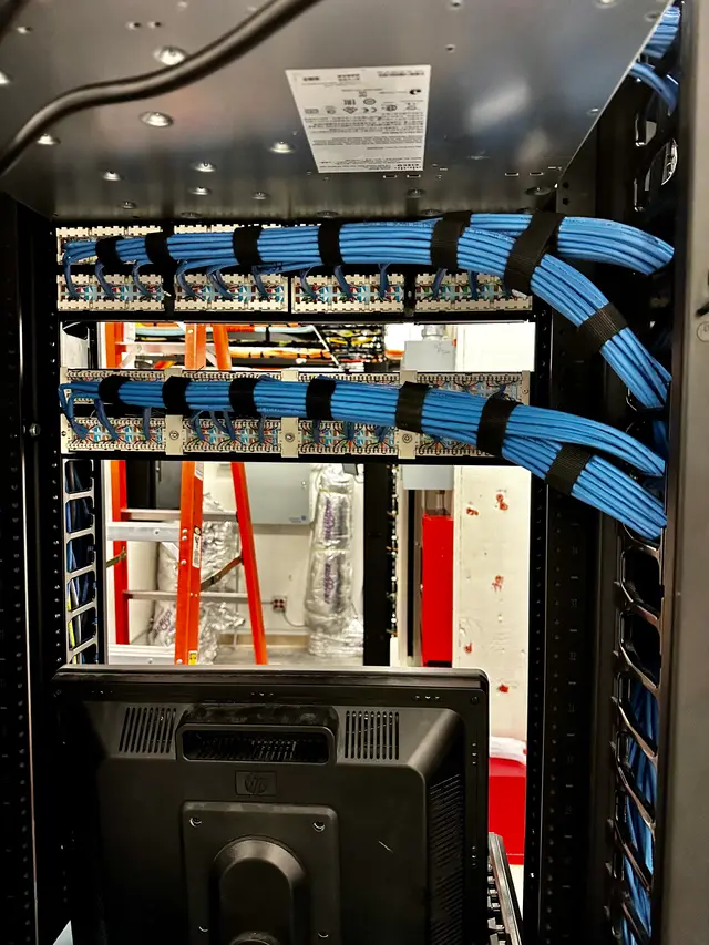 Top-of-rack cable entry with combed Cat6 bundles feeding patch panels